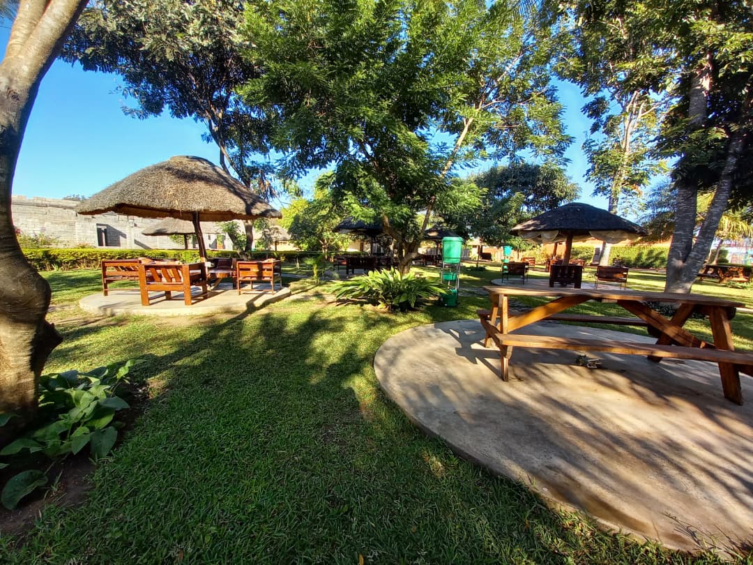 Outdoor seating beneath the trees at Kumudzi Innovation Centre